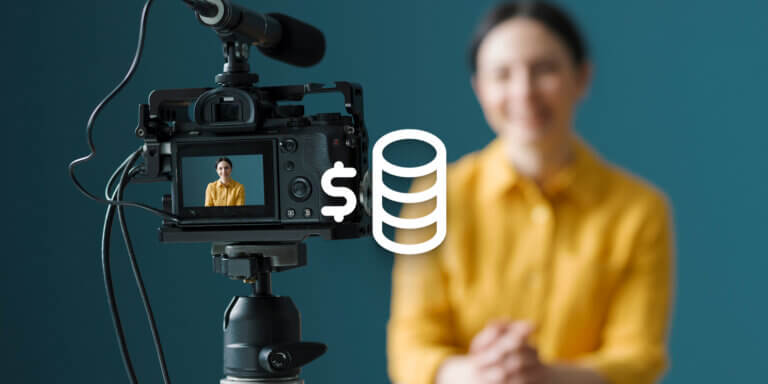 An image showing a video camera recording a woman wearing a yellow shirt.