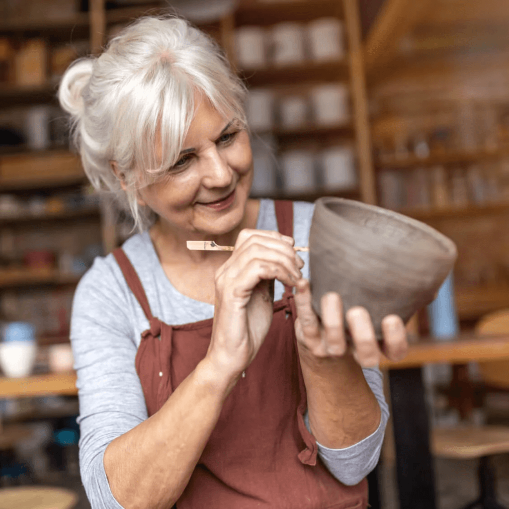 An artist creates a clay mug.