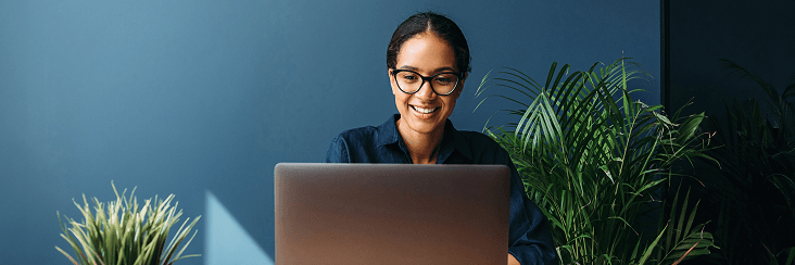 Professional working on a laptop at a desk.