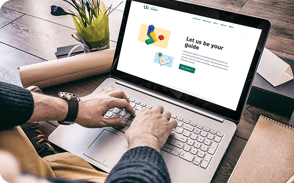 Person typing on a laptop next to a testimonial card about Workable improving onboarding with LearnWorlds analytics, with a “Discover Workable’s story” button.