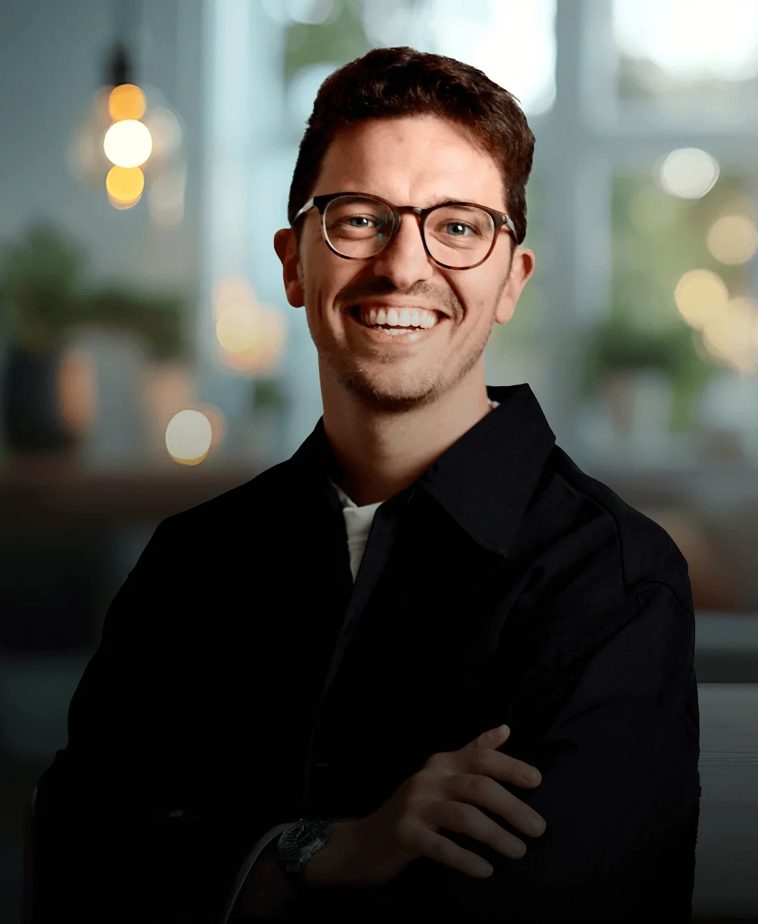 Man in a tan coat smiling and talking on a phone while holding coffee; standing by a modern office façade; left-side hero text and buttons promote a...